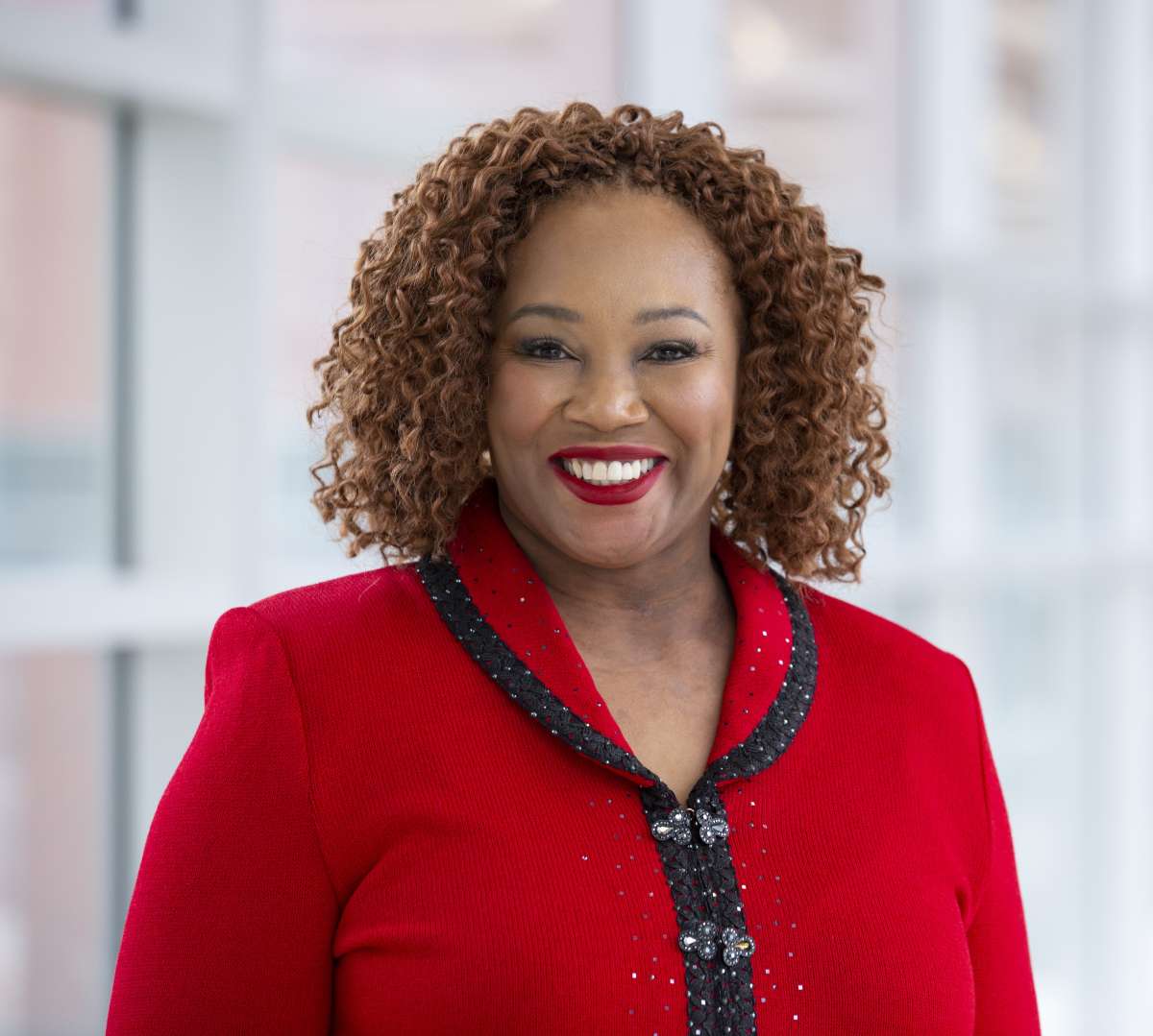 A headshot of Dr. Toyia Younger wearing a red blazer